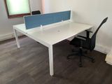 a white desk with a blue privacy panel on top of it