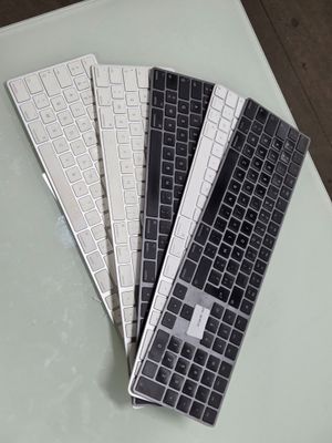 three keyboards sitting on a table next to each other
