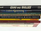 several books are stacked on top of each other on a table