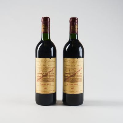 deux bouteilles de vin rouge posées l'une à côté de l'autre sur une surface blanche