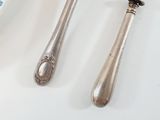 two spoons and a fork sitting on a table