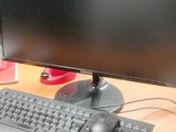 a computer monitor and keyboard on a desk