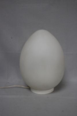 a white lamp that is sitting on a table
