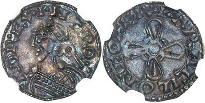 a close up of two silver coins on a white surface