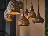 three lamps hanging from a ceiling in a dark room