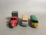 three toy trucks sitting next to each other on a table