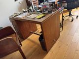a desk with a chair and a computer on it