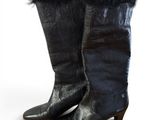 a pair of black leather boots with fur on the toes