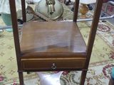 a small table with a lamp on top of it in a room