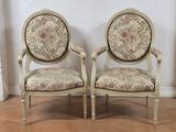 pair of french louis xvi style armchairs with floral upholstered upholstered cushions