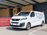 a white van that is parked in front of a building
