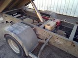 a truck with a trailer attached to the back of it