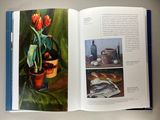 an open book with a picture of a potted plant in it