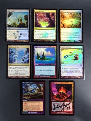 several cards are arranged on a black surface with a black background