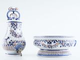 two vases and a bowl on a white surface