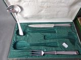 silverware in a green case on a table with silverware in it