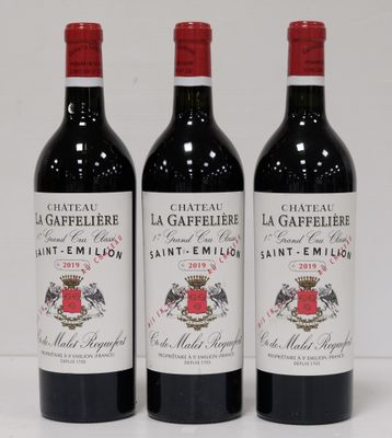 three bottles of wine sitting on top of a white table