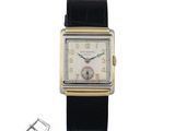 une image représentant une montre et une boucle sur fond blanc