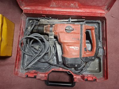 a red box with a hammer and other tools in it