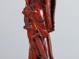 an image of a wooden statue of a man holding a sword