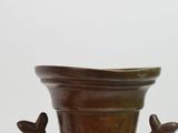 a brown vase with two birds on it