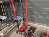 a picture of a garage with tools and equipment on the floor