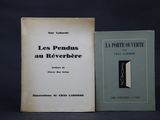 two books sitting next to each other on a black surface