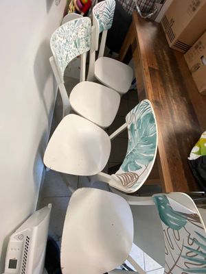 four chairs that are sitting in a row on the floor