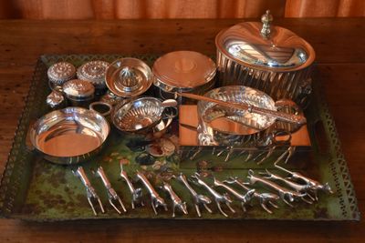 a tray with silverware on it on a wooden table