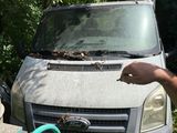 a man standing next to a van with a hose in front of it