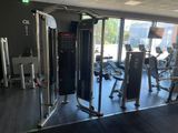 an image of a gym room with equipment and a lot of windows