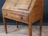 an old wooden writing desk with a drawer on top of it