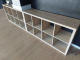 a wooden shelf with several shelves on it in a room