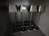 five speakers that are on a shelf in a room