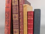 several old books are stacked on top of each other on a table