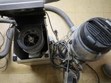a blow dryer sitting on the floor next to a laptop computer