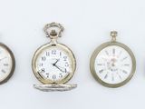 four different types of pocket watches displayed on a white surface