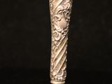an antique silver spoon with a decorative design on it