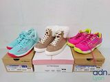 three pairs of girls ' s tennis shoes in boxes on a white surface