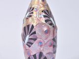 a vase with a design on it sitting on a table