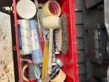 a red tool box with tools in it on the floor