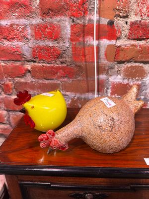 un vase jaune posé sur une table, à côté d'un autre vase jaune