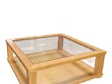 a wooden table with a glass top on a white background