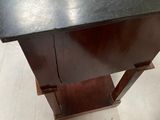 a black table with a black top on a white floor