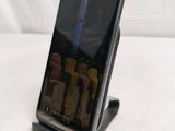 a cell phone that is on a stand on a table