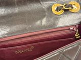 someone is holding a purse that has a chain on it