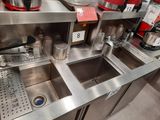 a stainless steel sink in the middle of a kitchen