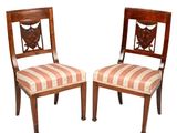 deux chaises en bois dont les assises sont recouvertes d'un tissu rayé sur fond blanc