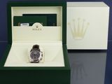 a rolex watch in a box on a table