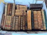 a box full of old books sitting on a table